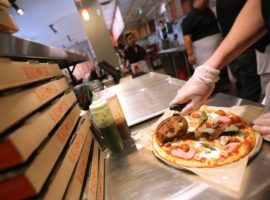 TORONTO, ON - OCTOBER 11: Blaze Pizza employees making customized pizza for customers at the Build Your Own Pizza counter at Blaze Pizza on Dundas St E at Yonge Street in Toronto. (Vince Talotta/Toronto Star via Getty Images) Photographer: Vince Talotta/Toronto Star